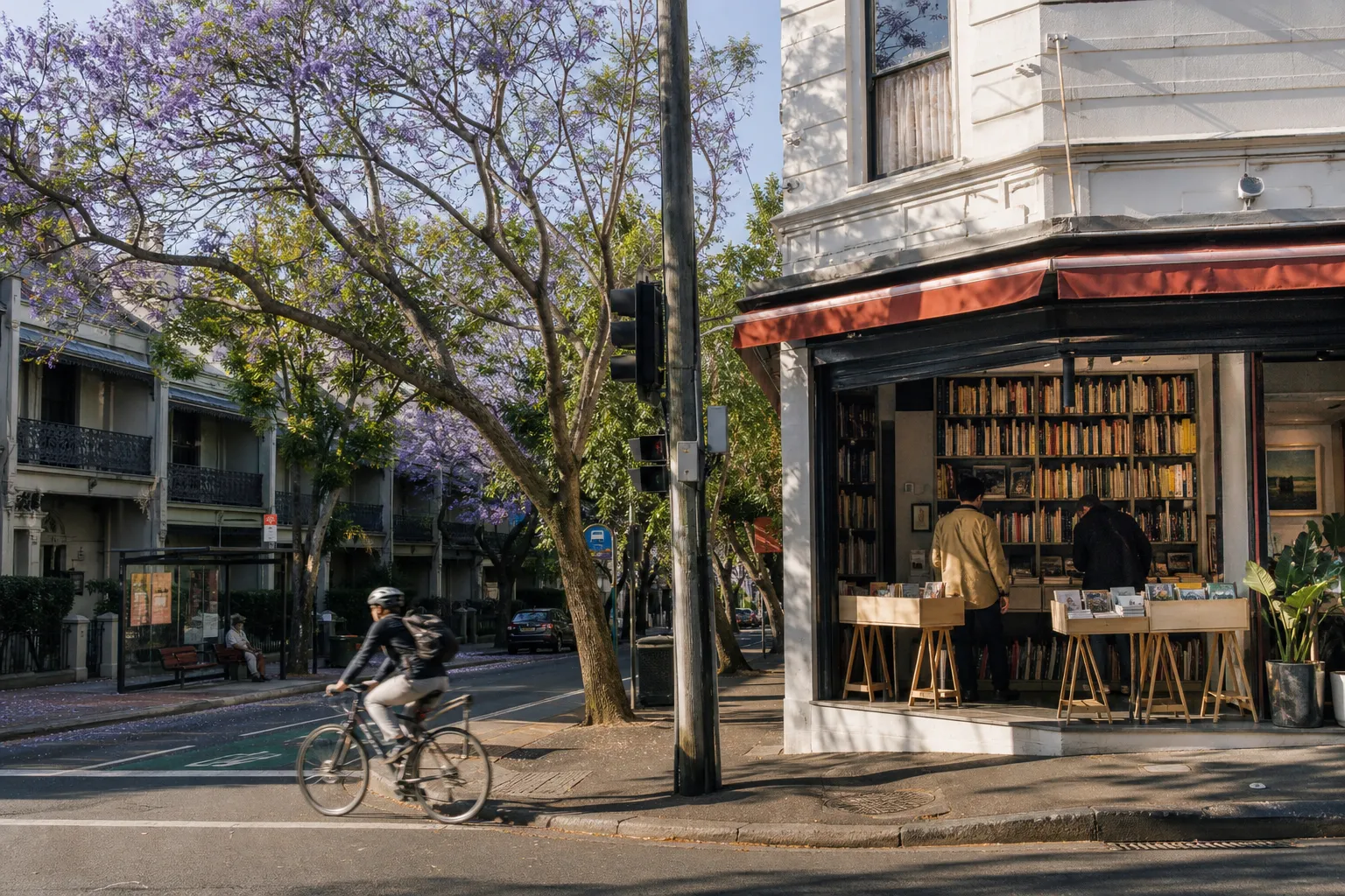 Bookshop and cyclist on a tree-lined Paddington street